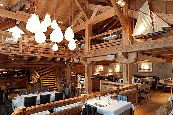 an image of a room with hanging lights and a miniature boat on one side